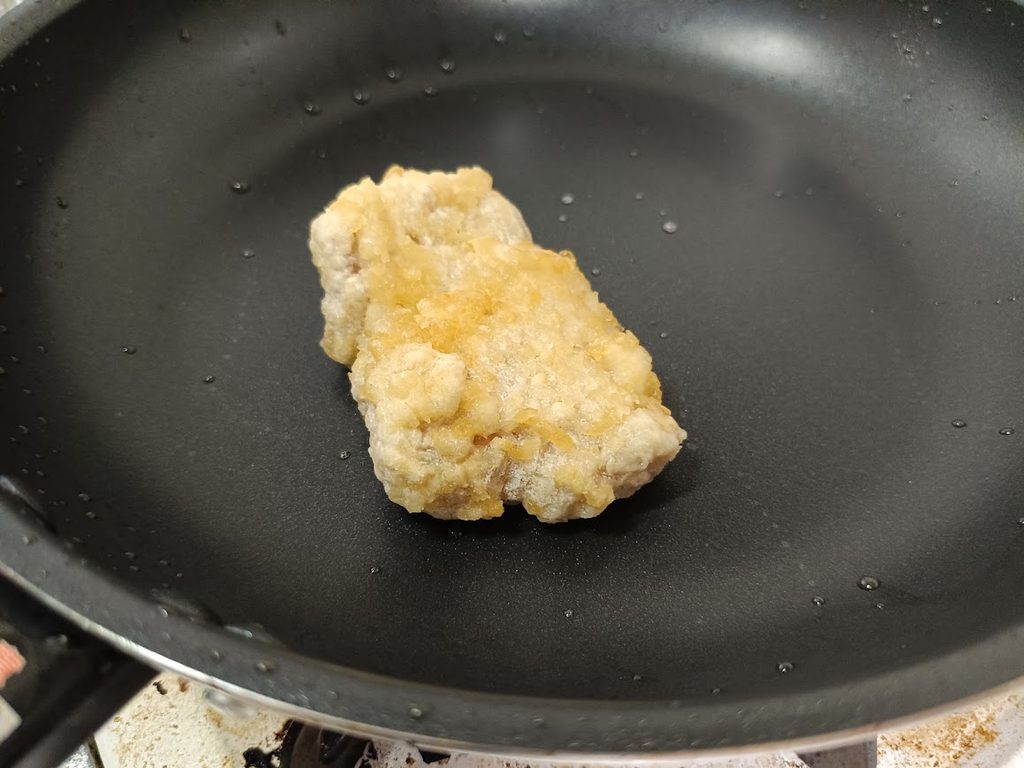 フライパンで調理しているジューシー油淋鶏セットのチキン